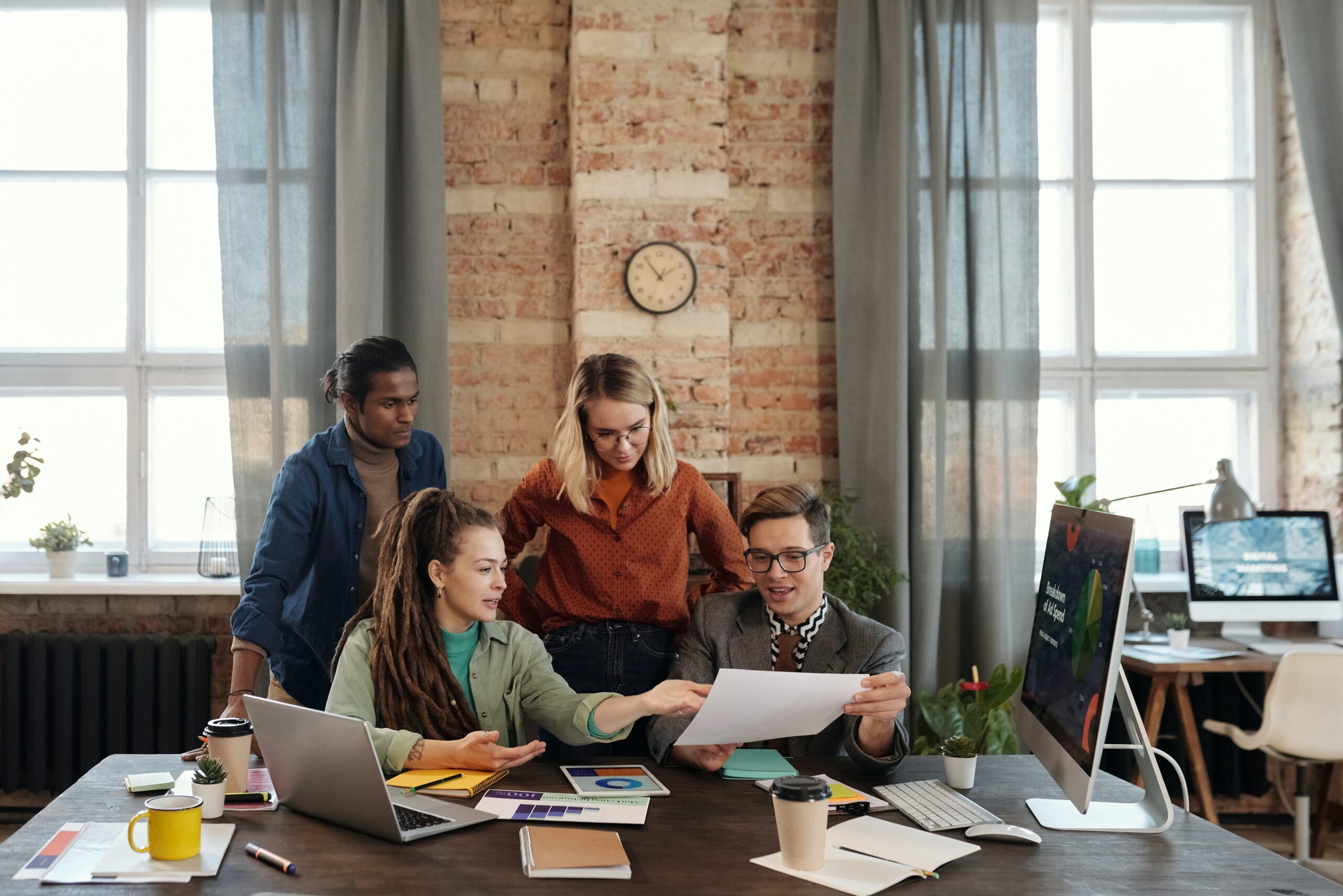 four employees at desk