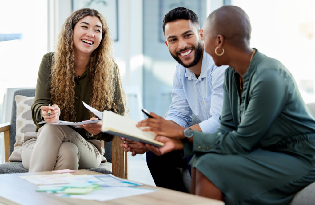 Happy Business People Smile During A Planning Meeting In A Startup Marketing Agency Office