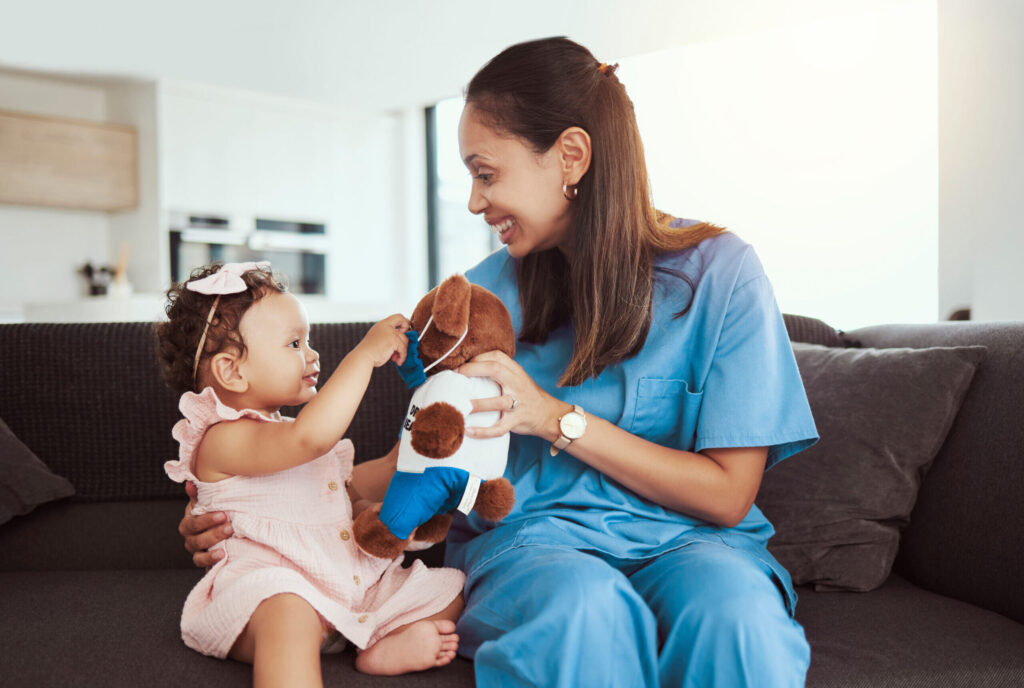 Pediatrician Doctor Consulting Kid, Teddy Bear And Happy Healthcare Checkup At Home Visit